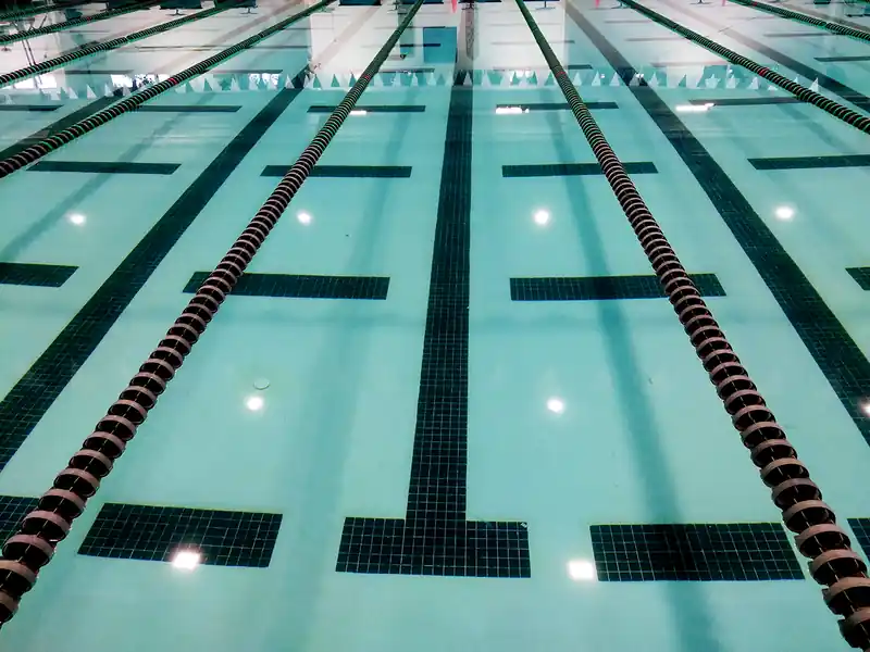Lane ropes and the black lane line on the pool floor, seen from the deck