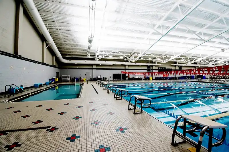 The long axis of the competition pool with starting blocks in the foreground